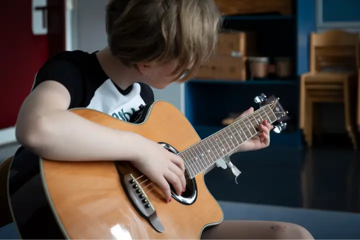 Ein Mädchen spielt akustische Gitarre